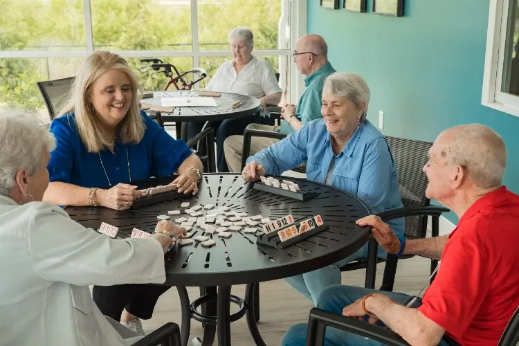 Residents laughing over a game of dominoes